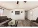 Open-concept living room with comfortable seating, laminate flooring, and plenty of natural light at 48773 Cerezo Rd # 20, Maricopa, AZ 85139
