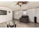 Cozy living room with laminate floors, featuring a modern ceiling fan and neutral decor at 48773 Cerezo Rd # 20, Maricopa, AZ 85139