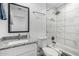 Bathroom features white marble-look tile throughout with a shower and tub combo at 5709 S 13Th Ave, Phoenix, AZ 85041