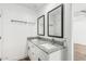 This bathroom has a dual sink granite vanity with dark framed mirrors and white cabinets at 5709 S 13Th Ave, Phoenix, AZ 85041