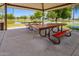 Covered picnic area featuring tables and benches amidst a flooded green space, offering shaded relaxation at 5709 S 13Th Ave, Phoenix, AZ 85041