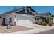 Home's exterior featuring a clean white garage door, well-kept yard, and charming curb appeal, highlighting its welcoming facade at 5709 S 13Th Ave, Phoenix, AZ 85041