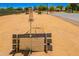 Outdoor game area with benches, providing community members a place to relax and enjoy a game of horseshoes at 5709 S 13Th Ave, Phoenix, AZ 85041