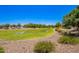Scenic view of the community park featuring lush green grass, gravel walking path, and mature trees, perfect for recreation at 5709 S 13Th Ave, Phoenix, AZ 85041