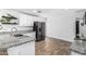 Modern kitchen featuring granite counters, stainless appliances, and wood-look floors at 5709 S 13Th Ave, Phoenix, AZ 85041