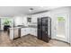Modern kitchen featuring granite counters, stainless appliances, and wood-look floors at 5709 S 13Th Ave, Phoenix, AZ 85041