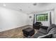 Cozy living room featuring wood-look floors, sofa, chair and large window at 5709 S 13Th Ave, Phoenix, AZ 85041