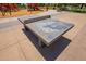 Outdoor ping pong table near playground, offering Gathering fun and recreational activity in the community at 5709 S 13Th Ave, Phoenix, AZ 85041
