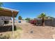 Large backyard with desert landscaping, including a covered patio area, and a privacy fence at 5807 W Encanto Blvd, Phoenix, AZ 85035
