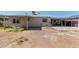 View of backyard and covered patio, with some plants, dirt, and gravel areas at 5807 W Encanto Blvd, Phoenix, AZ 85035