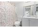 Compact bathroom with a sink, toilet, and Paris-themed shower curtain. Clean and functional at 5807 W Encanto Blvd, Phoenix, AZ 85035