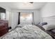 Bright bedroom offers a ceiling fan, large window, and a comfortable bed for a serene living space at 5807 W Encanto Blvd, Phoenix, AZ 85035