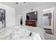 Spacious bedroom with ceiling fan, and TV, offers a bathroom, and closet for maximized storage at 5807 W Encanto Blvd, Phoenix, AZ 85035