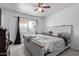 Cozy bedroom features a ceiling fan, large window, and a comfortable bed perfect for relaxation at 5807 W Encanto Blvd, Phoenix, AZ 85035