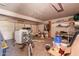 A cluttered residential garage with white garage door and miscellaneous household items at 5807 W Encanto Blvd, Phoenix, AZ 85035