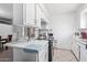 Bright kitchen showcasing white cabinets and countertops, complemented by tile flooring for a clean, classic look at 5807 W Encanto Blvd, Phoenix, AZ 85035