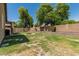 Spacious backyard featuring a charming fire pit, well-maintained landscaping, and a private block fence at 609 S 122Nd Dr, Avondale, AZ 85323