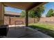 Covered patio seating in a spacious backyard with brick wall, designed for relaxing and entertaining at 609 S 122Nd Dr, Avondale, AZ 85323