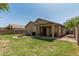 Expansive backyard with covered patio, and well-maintained lawn, creating a serene outdoor space at 609 S 122Nd Dr, Avondale, AZ 85323