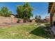 Spacious backyard with lush lawn and brick accents, perfect for outdoor enjoyment and entertaining at 609 S 122Nd Dr, Avondale, AZ 85323