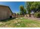 Lush backyard featuring a well-kept lawn, a fire pit, and a covered patio creating an inviting outdoor area at 609 S 122Nd Dr, Avondale, AZ 85323