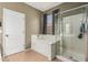 Bathroom featuring a separate shower, soaking tub, and tiled flooring, creating a functional and visually appealing space at 609 S 122Nd Dr, Avondale, AZ 85323