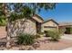 Charming single-Gathering home with a two-car garage, desert landscaping, and mature tree at 609 S 122Nd Dr, Avondale, AZ 85323