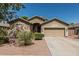Charming single-Gathering home with a two-car garage, desert landscaping, and well-manicured shrubs at 609 S 122Nd Dr, Avondale, AZ 85323