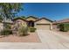 Charming single-Gathering home with a two-car garage, desert landscaping, and well-manicured shrubs at 609 S 122Nd Dr, Avondale, AZ 85323