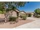 Charming single-Gathering home with a two-car garage, desert landscaping, and mature tree at 609 S 122Nd Dr, Avondale, AZ 85323