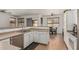 Bright kitchen featuring stainless steel appliances, white cabinets, and a seamless flow into the adjacent dining area at 609 S 122Nd Dr, Avondale, AZ 85323