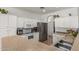 Spacious kitchen features stainless steel appliances, white cabinets, a breakfast bar, and ample counter space at 609 S 122Nd Dr, Avondale, AZ 85323