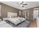 Relaxing main bedroom featuring a ceiling fan, neutral colors, and access to the bathroom and walk-in closet at 609 S 122Nd Dr, Avondale, AZ 85323