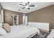 Bedroom with a ceiling fan, neutral colors, and generous closet space providing a serene and organized retreat at 609 S 122Nd Dr, Avondale, AZ 85323