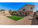 Large backyard featuring a putting green with desert landscaping and covered patio at 640 W Country Estates Ave, Gilbert, AZ 85233