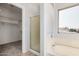 Bright bathroom with shower, bath, closet and natural light from the window at 640 W Country Estates Ave, Gilbert, AZ 85233