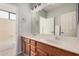 A modern bathroom featuring a double vanity with a large mirror and a separate door to toilet and shower area at 640 W Country Estates Ave, Gilbert, AZ 85233