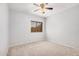 A cozy bedroom with neutral walls, carpet flooring, and a window that allows plenty of sunlight at 640 W Country Estates Ave, Gilbert, AZ 85233
