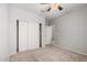 A bedroom with neutral walls, carpet flooring, and a closet for easy clothing storage at 640 W Country Estates Ave, Gilbert, AZ 85233