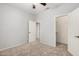 A well-lit bedroom featuring neutral walls, carpet flooring, and a walk-in closet for storage at 640 W Country Estates Ave, Gilbert, AZ 85233