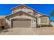 Charming two-story home featuring a tan stucco exterior, two-car garage, and low-maintenance desert landscaping at 640 W Country Estates Ave, Gilbert, AZ 85233