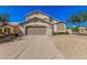 Charming two-story home featuring a tan stucco exterior, two-car garage, and low-maintenance desert landscaping at 640 W Country Estates Ave, Gilbert, AZ 85233