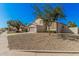 Two-story home featuring a tan stucco exterior and low-maintenance desert landscaping at 640 W Country Estates Ave, Gilbert, AZ 85233