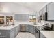 Well-lit kitchen with stainless steel appliances, gray cabinets, and white countertops at 640 W Country Estates Ave, Gilbert, AZ 85233