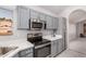 Modern kitchen with stainless steel appliances, quartz countertops, and gray cabinets at 640 W Country Estates Ave, Gilbert, AZ 85233