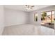 Bright living room features tile flooring, ceiling fan, and sliding door access to backyard at 640 W Country Estates Ave, Gilbert, AZ 85233