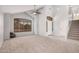 Bright living room with vaulted ceilings, large windows, neutral carpet, and tiled entryway at 640 W Country Estates Ave, Gilbert, AZ 85233