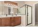 Bathroom featuring dual vanities, a glass shower and neutral tones at 6936 E Snowdon St, Mesa, AZ 85207