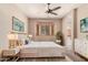 Cozy bedroom with a ceiling fan, neutral walls, and plenty of natural light from the windows at 6936 E Snowdon St, Mesa, AZ 85207