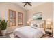 Cozy bedroom with a ceiling fan, neutral walls, and plenty of natural light from the windows at 6936 E Snowdon St, Mesa, AZ 85207
